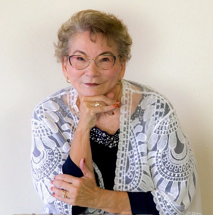 Donna Stanton, smiling with her chin resting on her hand